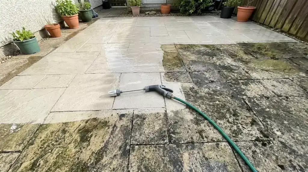 Jetterix test on a 32 m² stone patio — clear line between cleaned and uncleaned section