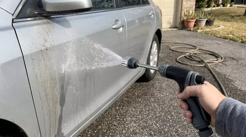 Jetterix test on a silver family wagon — soft fan spray hitting the driver's door directly